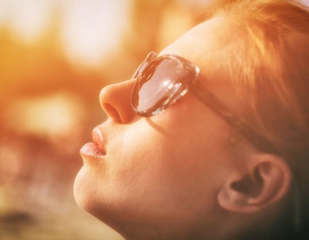 person with glasses looking up into the sky
