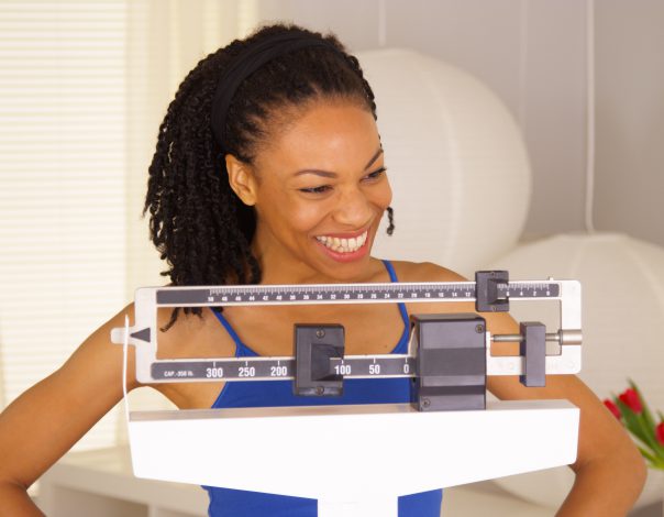 woman standing on mechanical scale.